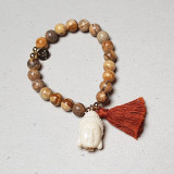 Bracelet pompon beige et Bouddha