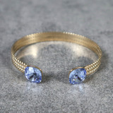 Jonc doré, effet tressé, cristaux carrés, bleu clair